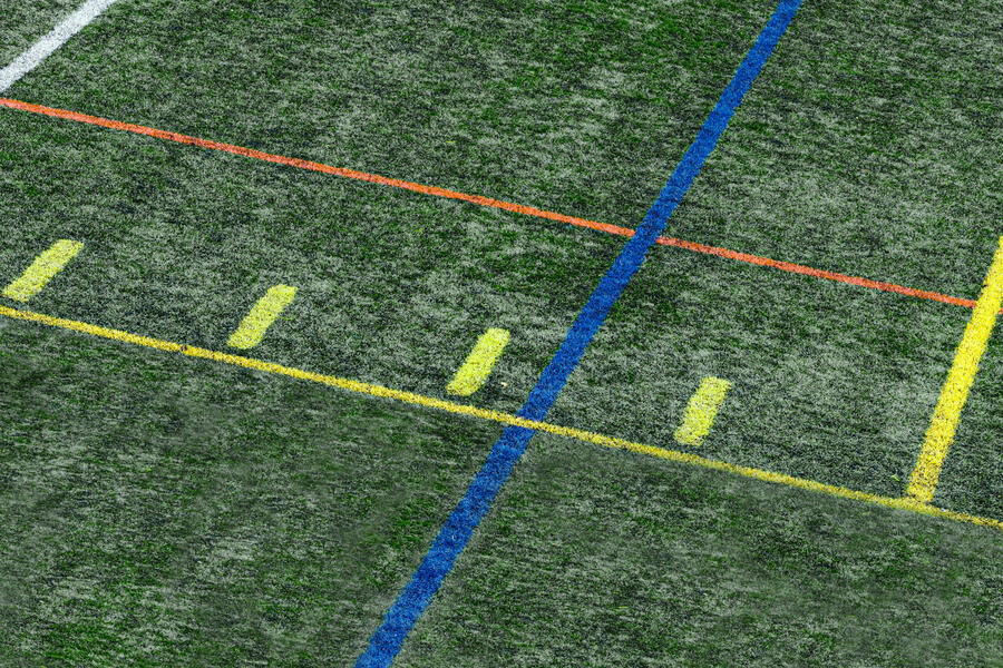 A green stadium's field with coloured lines defined for a sport