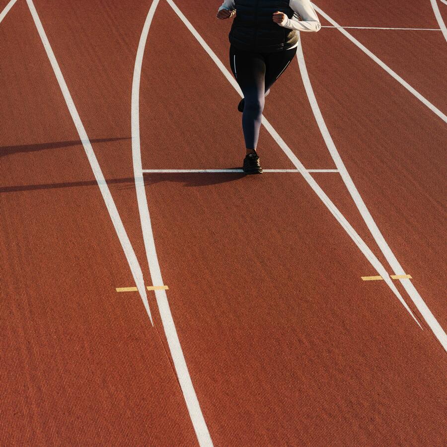 An athlete is running on the running track.