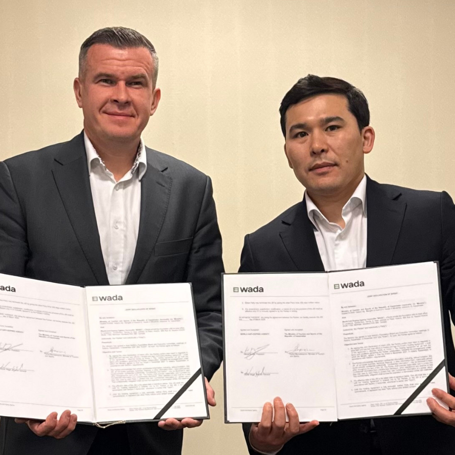 WADA President, Witold Bańka holding signed agreement of additional contribution with a representative of the Government of Kazakhstan