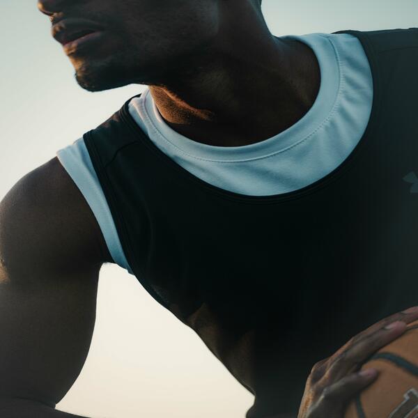 Basketball athlete holding the basketball in his hands, ready to pass it on.