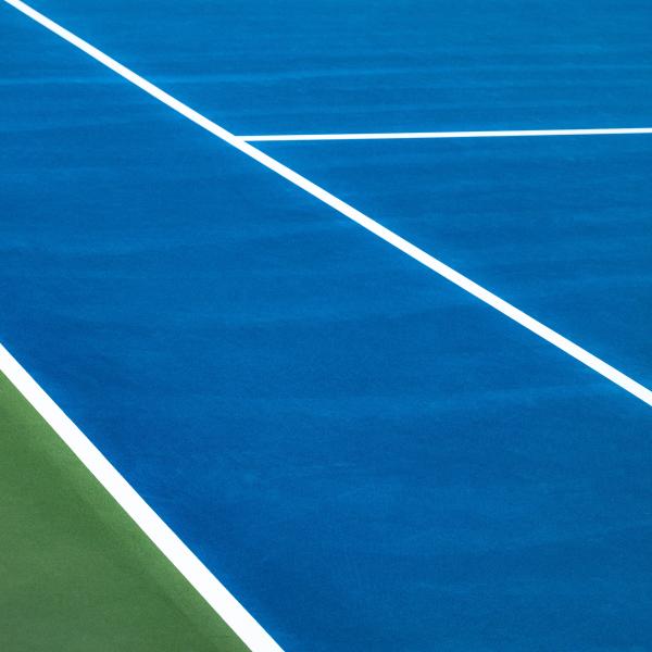 Blue tennis court with green sides